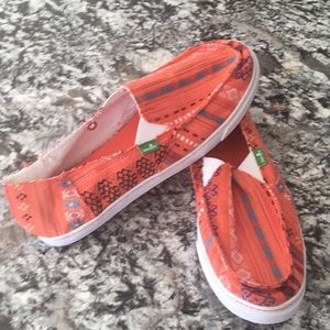 Sanuk slip on shoes.